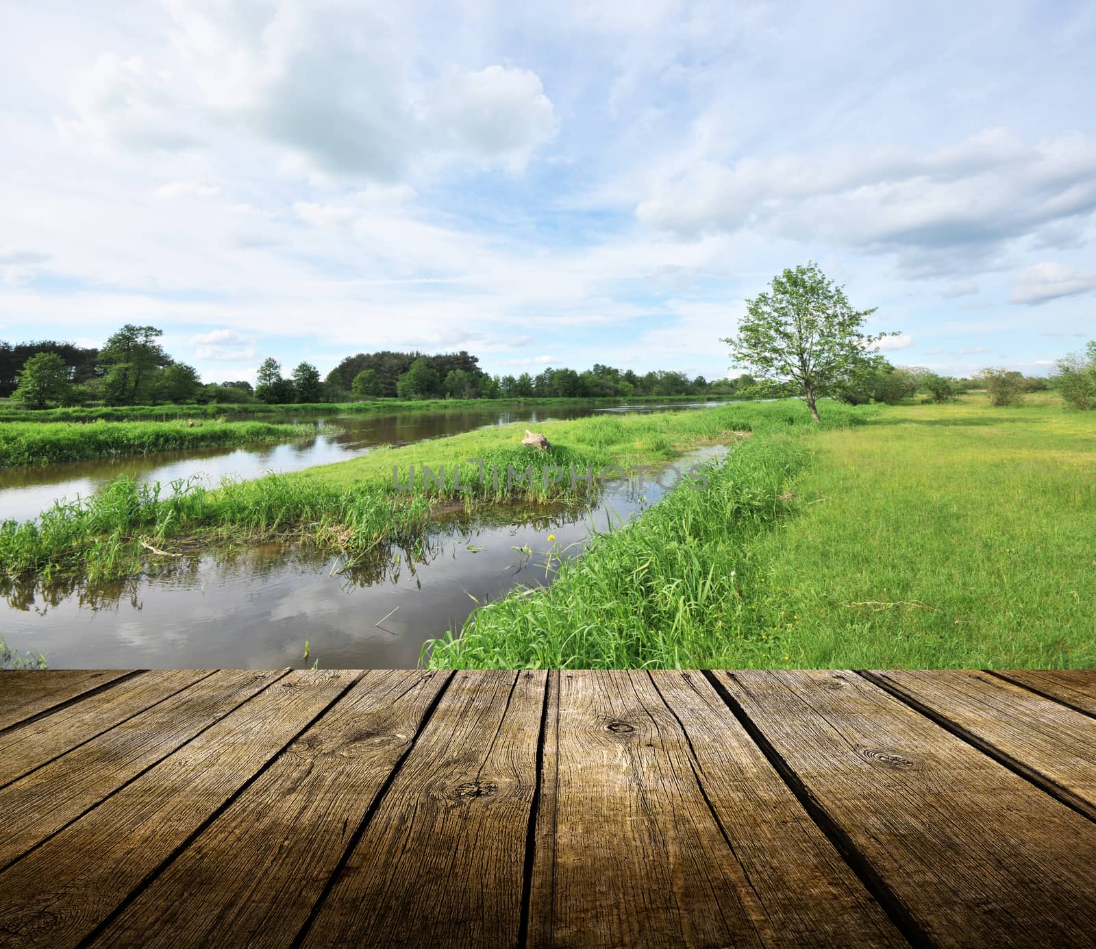 Empty wooden deck table with river in background. Ready for product display montage. 