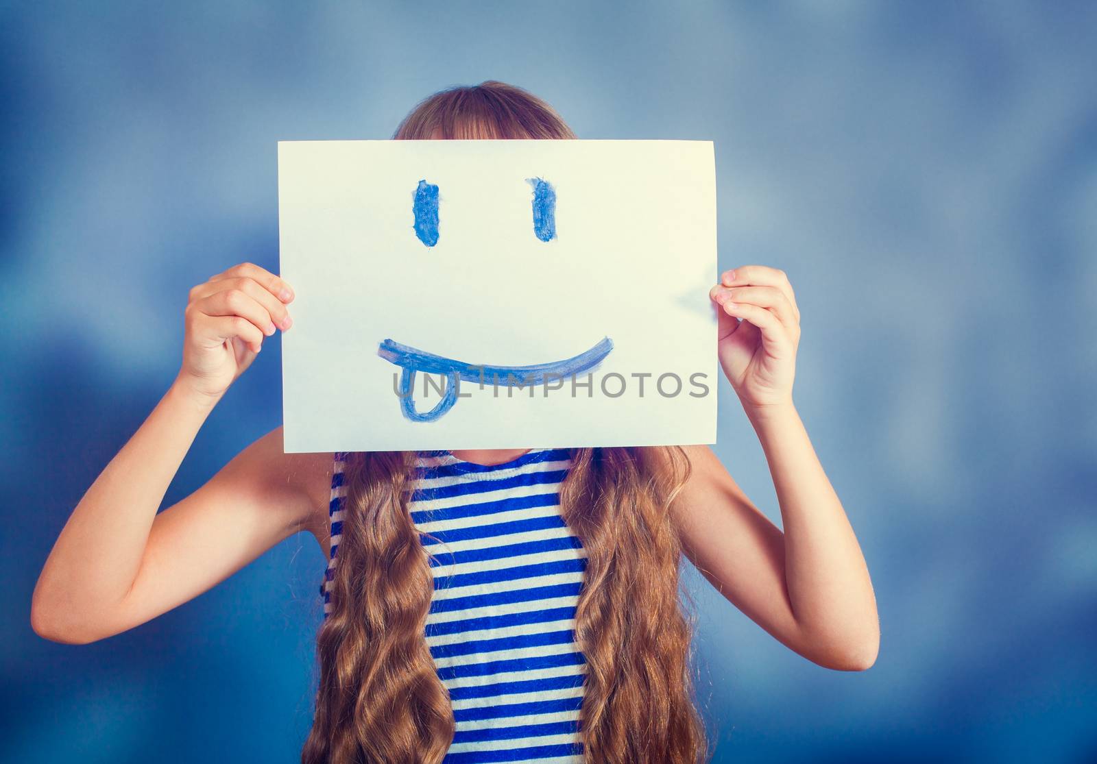 girl holding a picture of a smiling faces