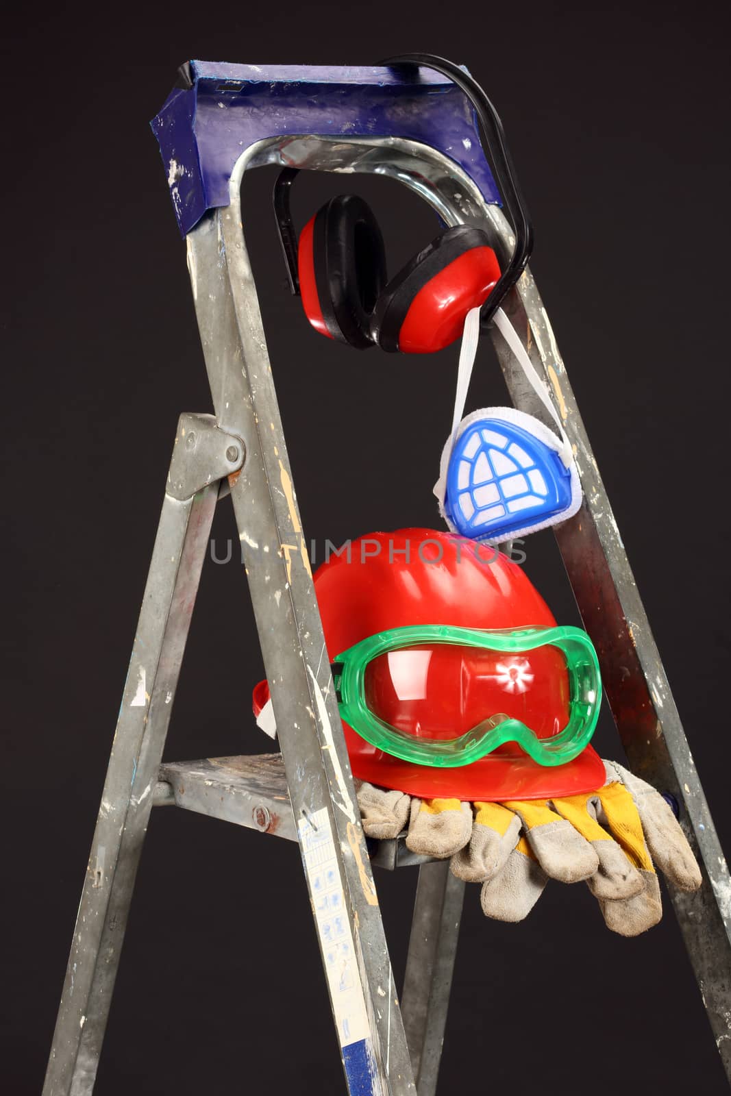 Safety gear kit on step ladder over black 