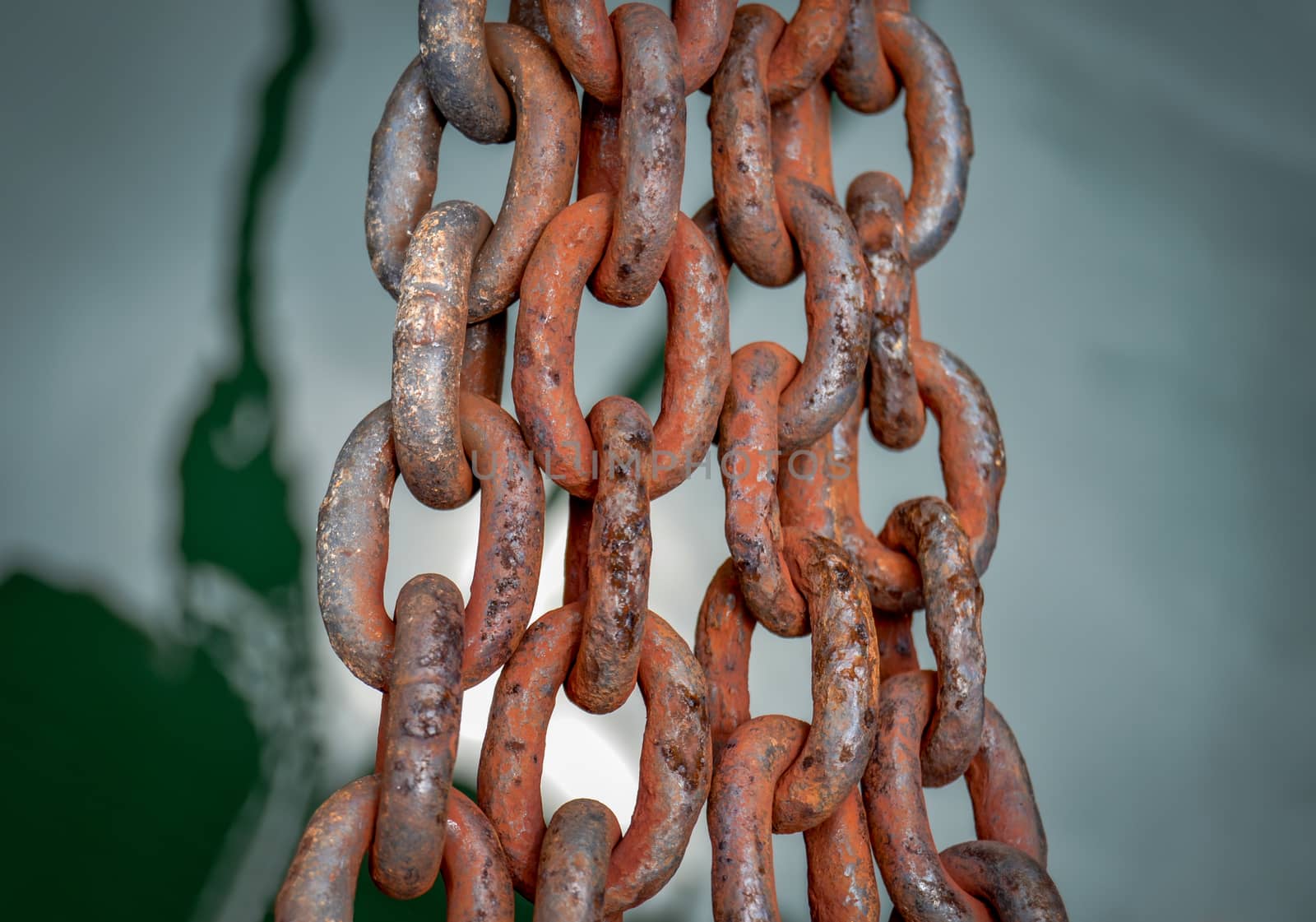 Nautical Image Of Rusty Chains Over Green, Still Ocean Water