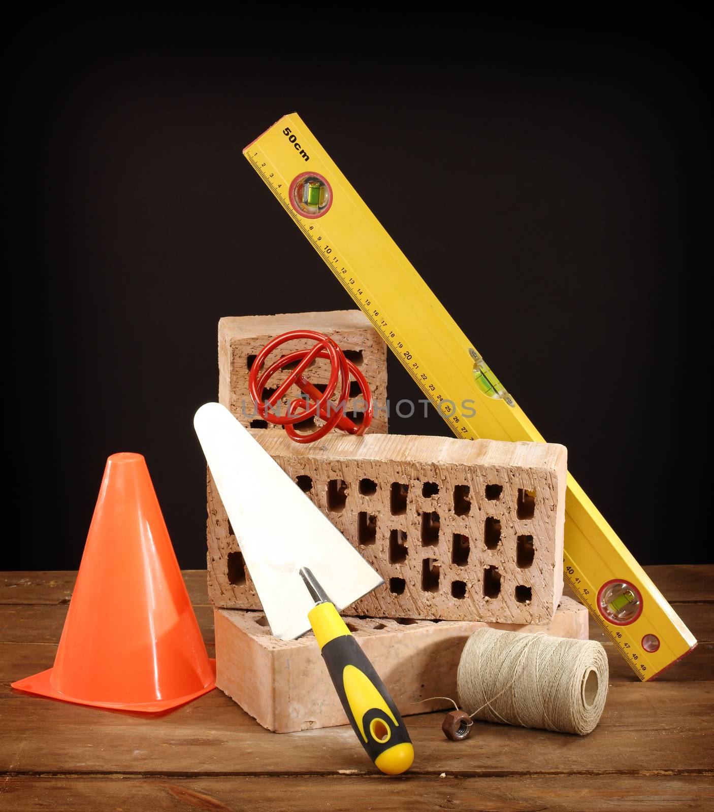 Bricks, trowel and stirrer on work place