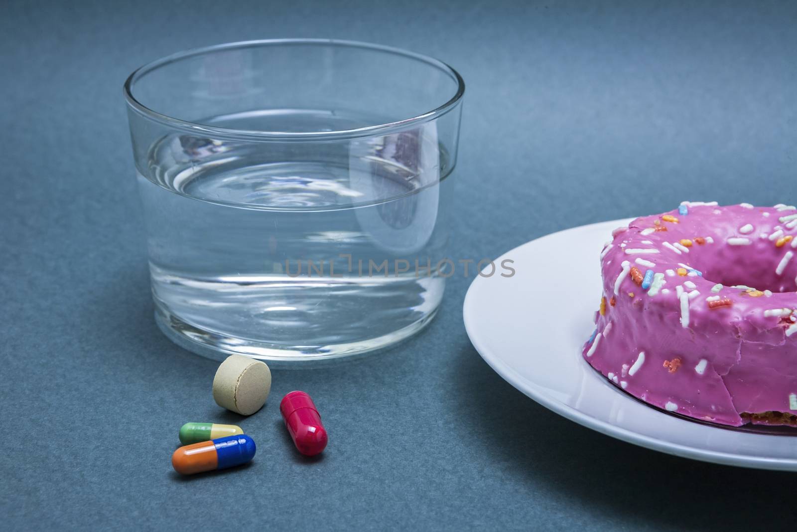 Various medicines to combat diabetes along with a sweet cake, concept of disease of hyperglycemia or diabetes