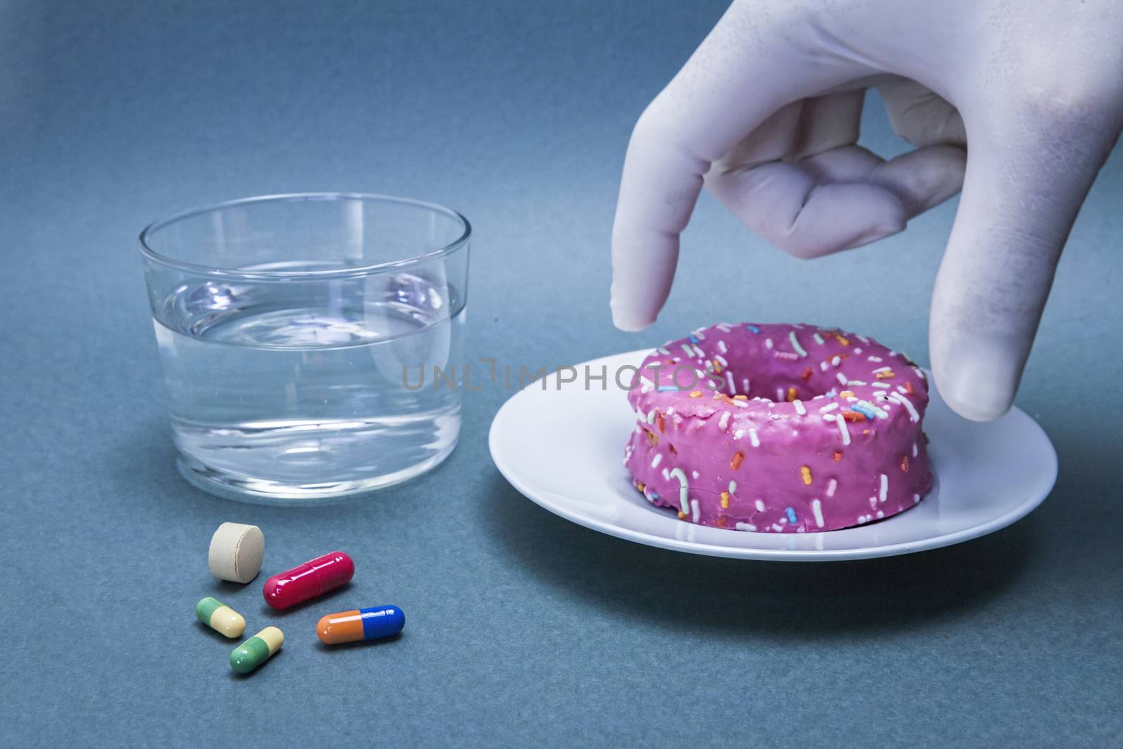 Various medicines to combat diabetes along with a sweet cake, concept of disease of hyperglycemia or diabetes