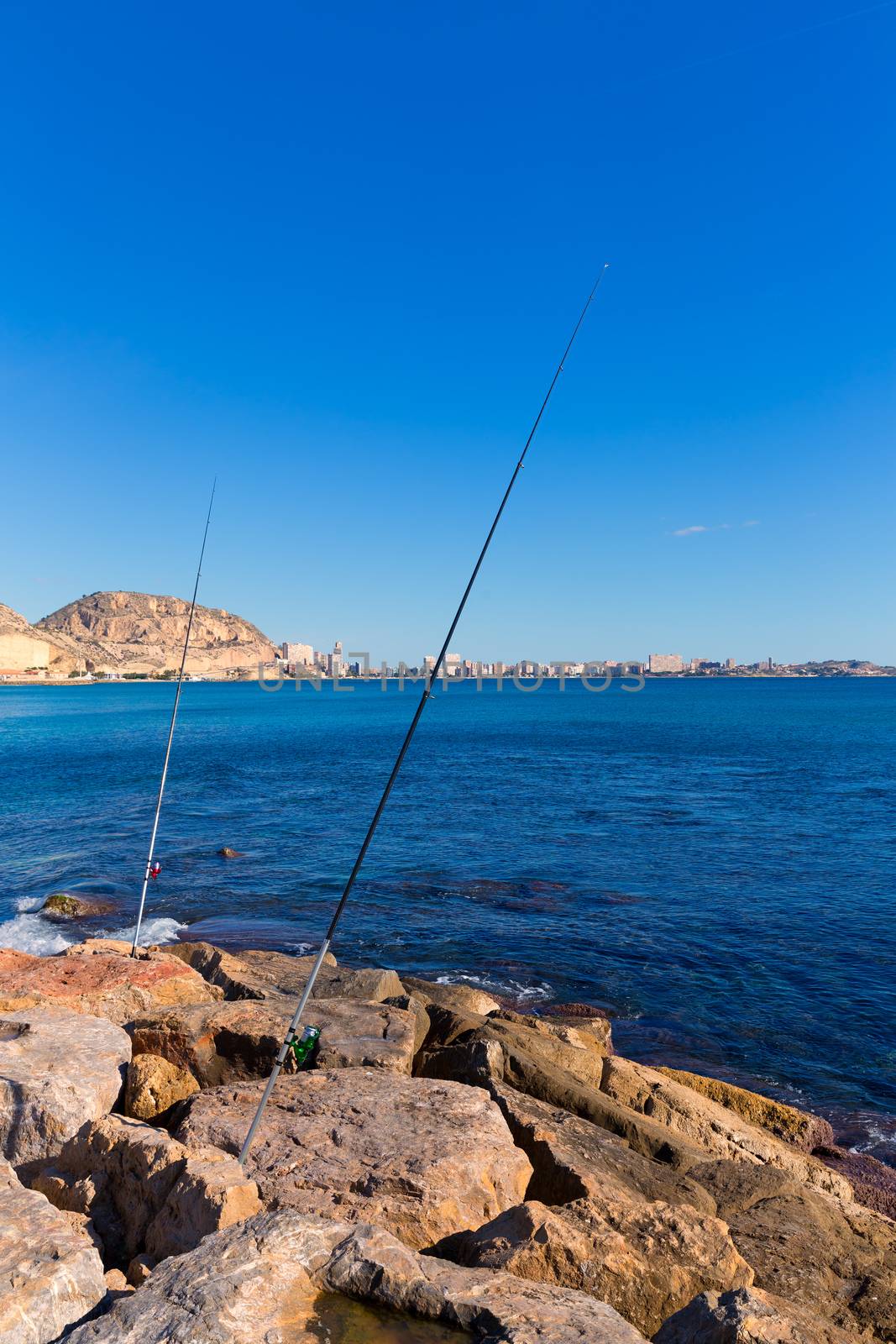 Alicante and san Juan fishing in breakwater at Spain Valencian Community