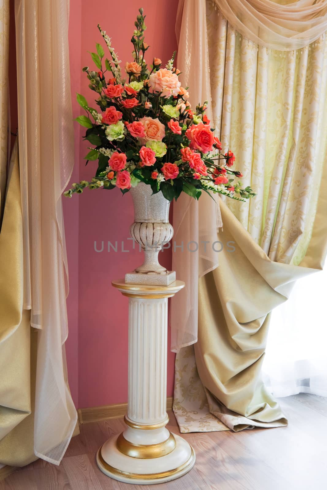 bouquet of beautiful flowers in the vase near the window