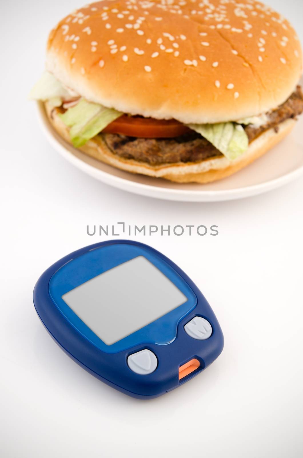 Glucometer and hamburger. Healthy lifestyle by simpson33