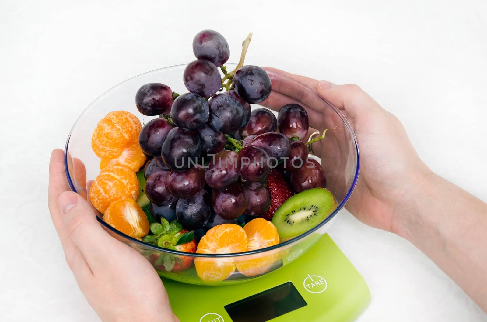 Lots of fruit on the kitchen scale in a modern kitchen
