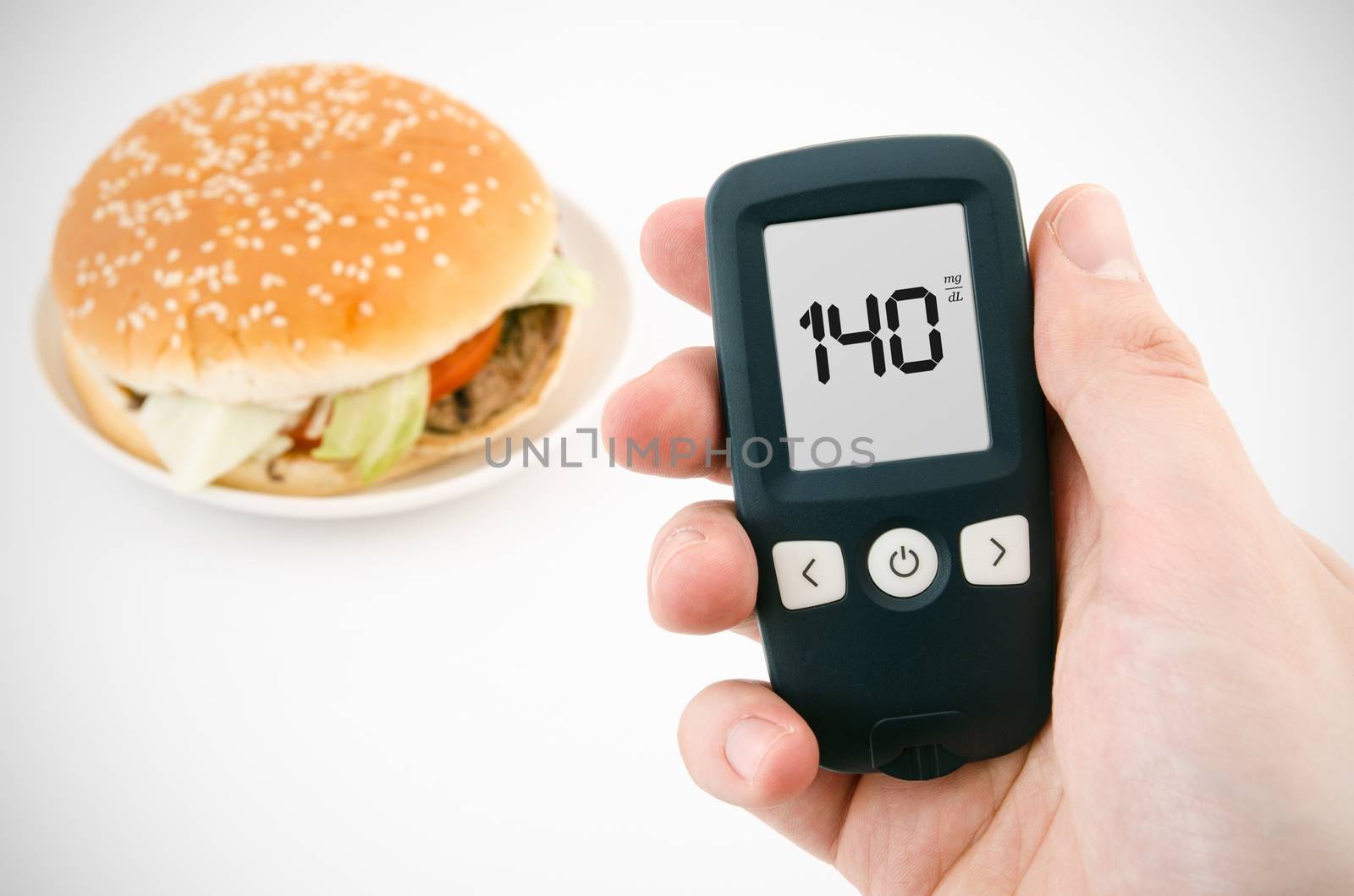 Hand holding meter. Diabetes doing glucose level test. Hamburger by simpson33