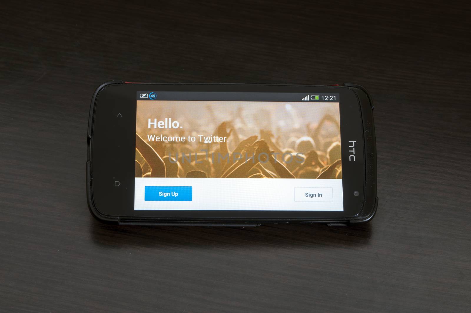 Bucharest, Romania -January 28, 2014: Photo of a HTC Desire device, showing the Twitter.com homepage of the Android app featuring the image of a crowd of hands with the message "Hello. Welcome to Twitter".