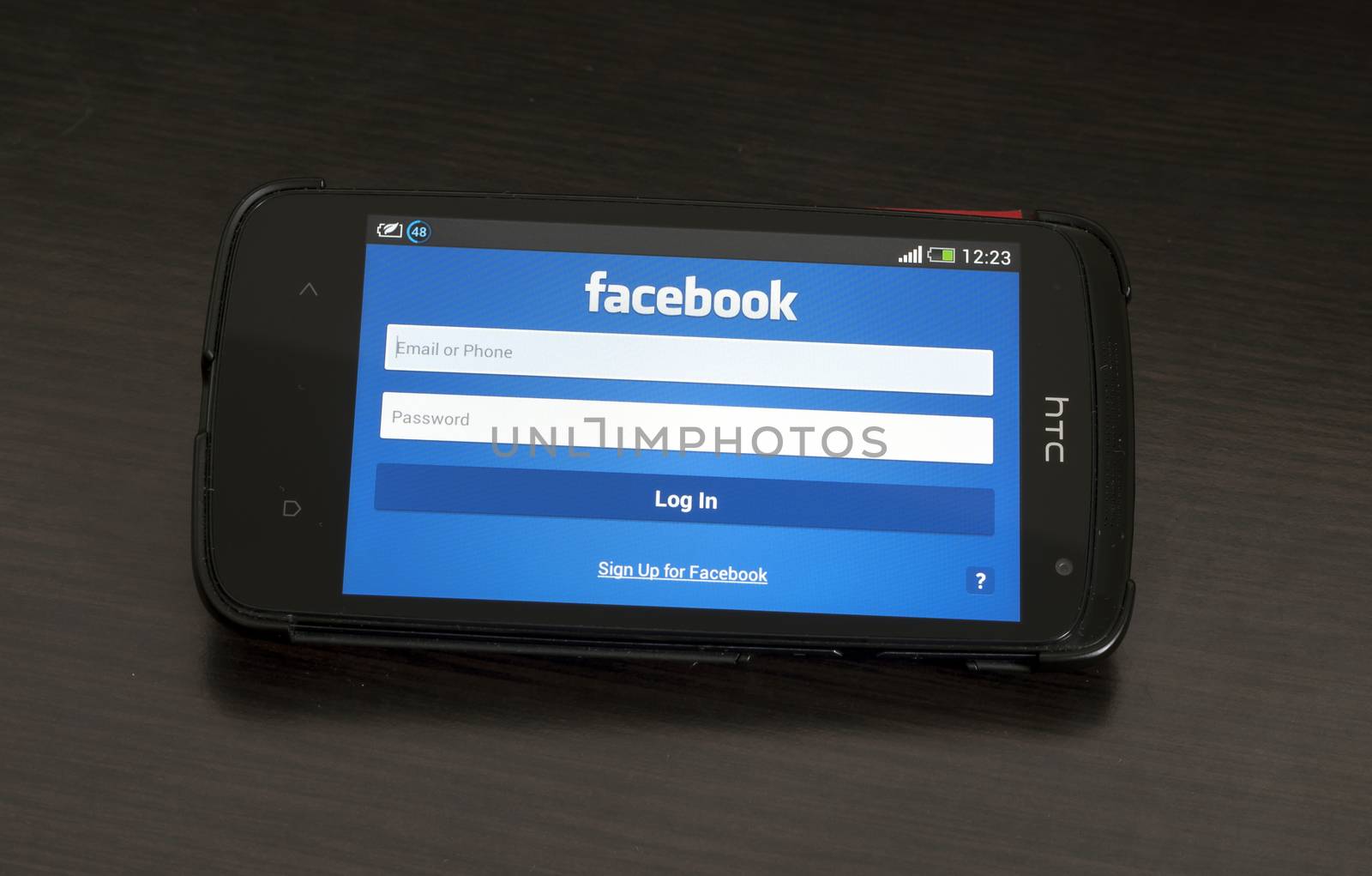 Bucharest, Romania - January 28, 2014: Photo of a HTC Desire device, showing the Facebook homepage of the Android app featuring the Log In formular.