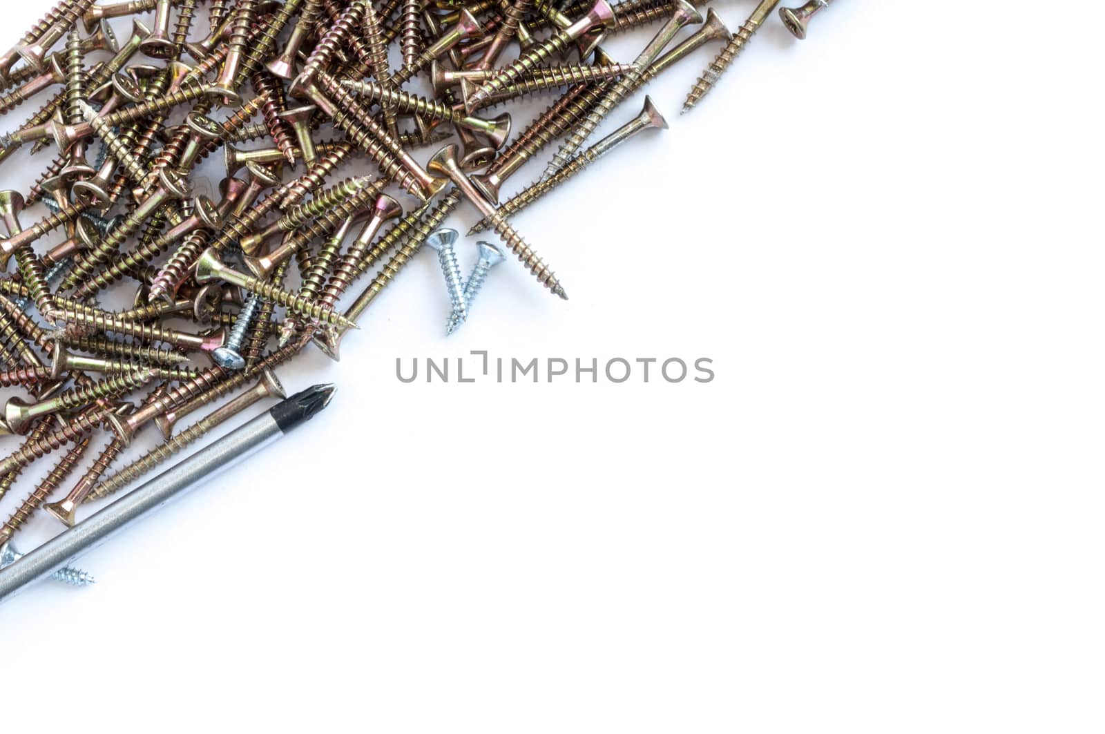 Set of screws and a screwdriver and glove over a white background with space for text