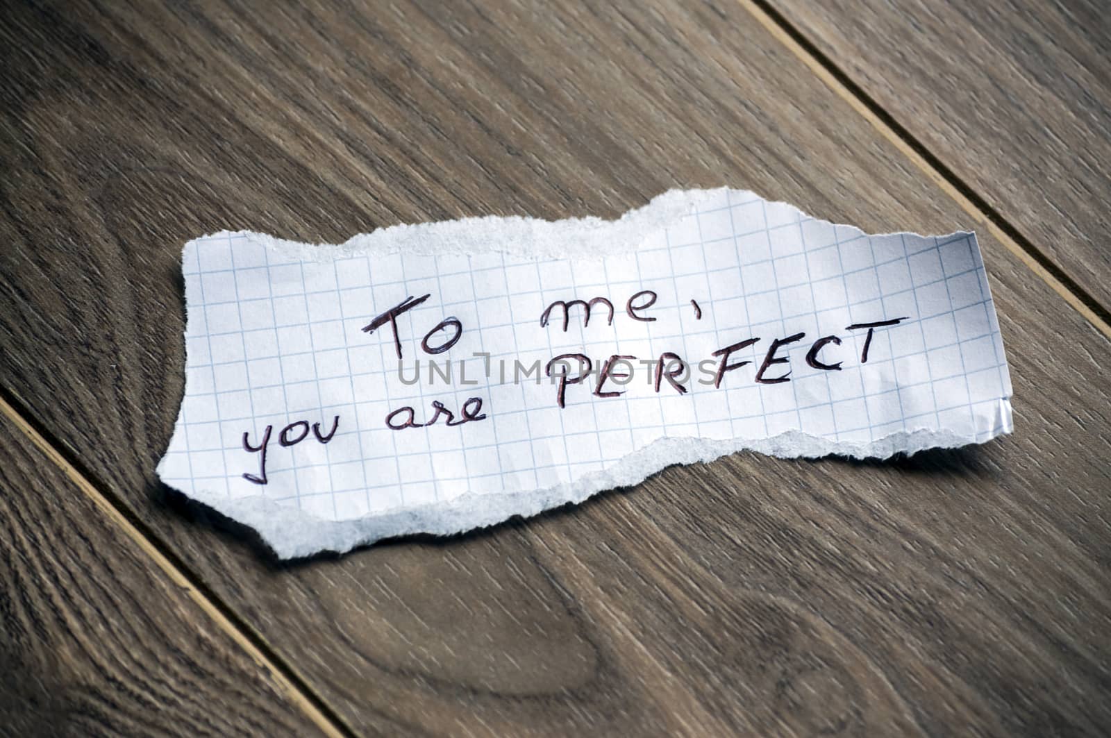 To me, you are Perfect - Hand writing text on a piece of paper on wood background