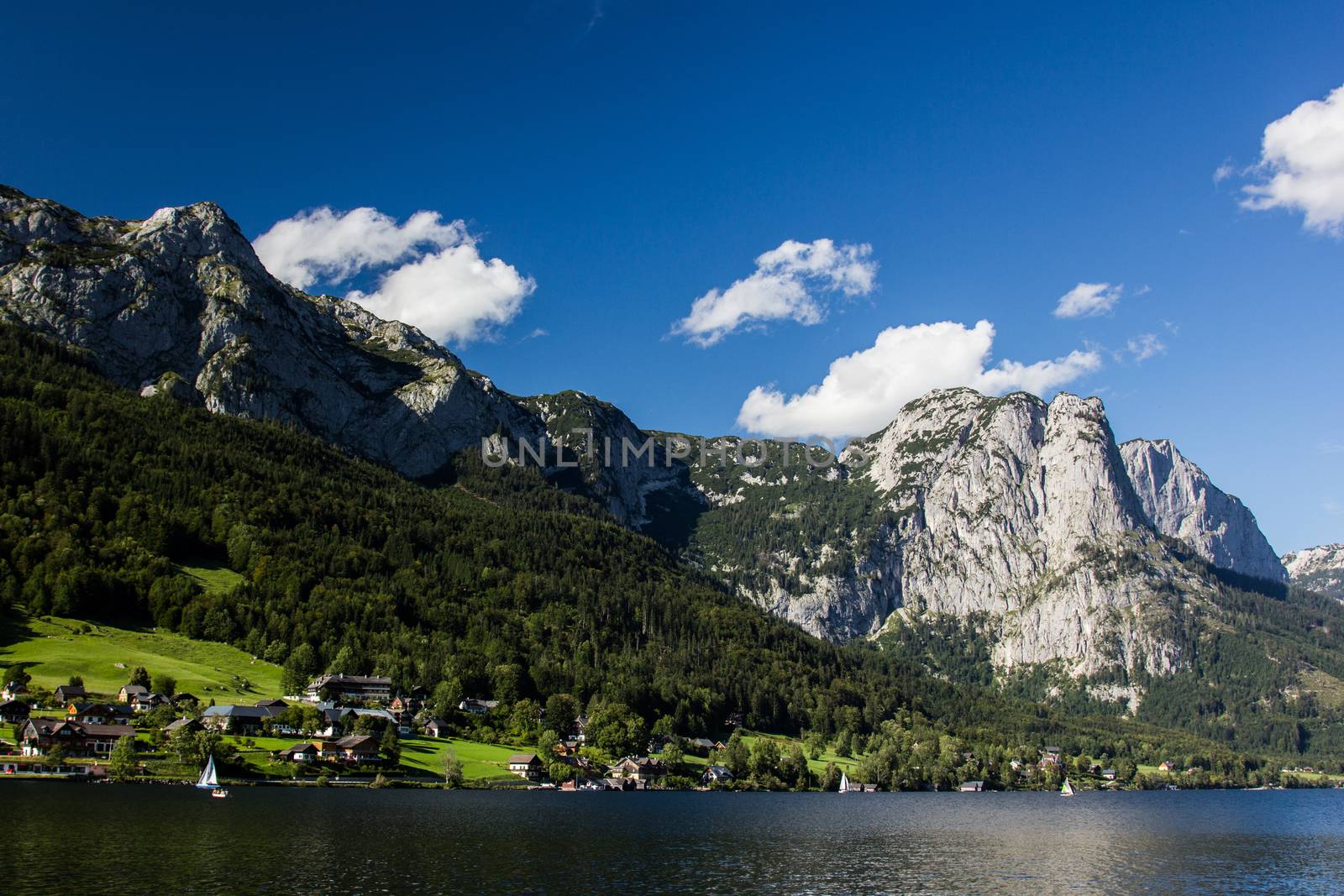 Small boat flowing on the lake in the mountains