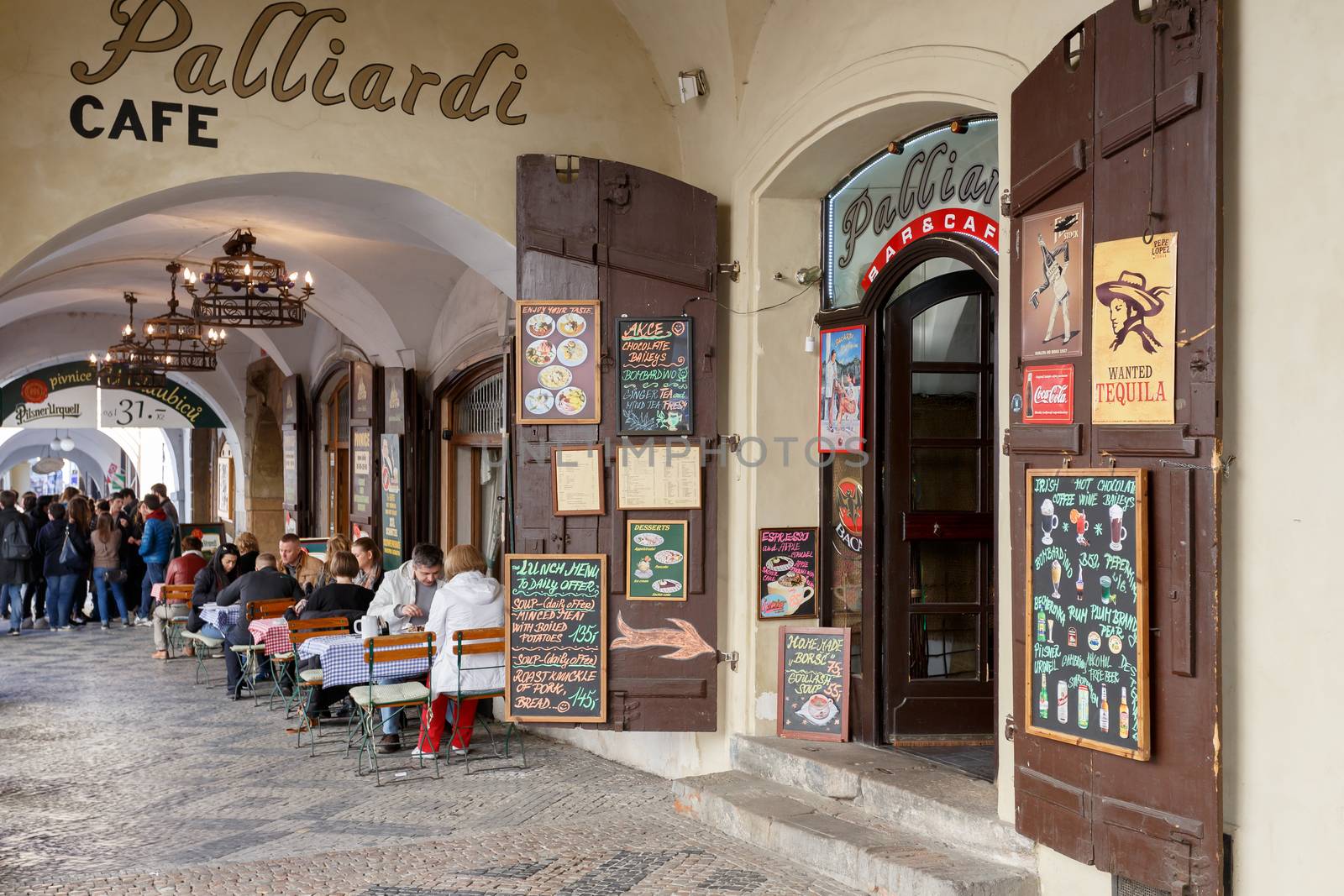 PRAGUE, CZECH REPUBLIC - MARCH 13th, 2014 - Prague shops and restaurants situated in historic center Little Quarter with relaxing tourists.