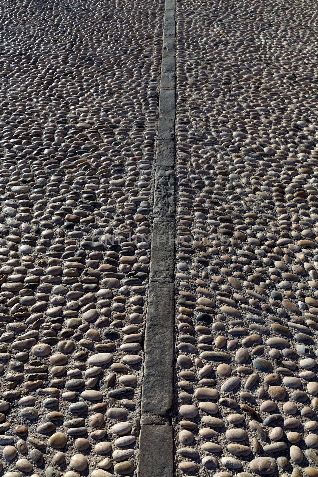 Rolling stones pavement soil texture in Altea Alicante by lunamarina