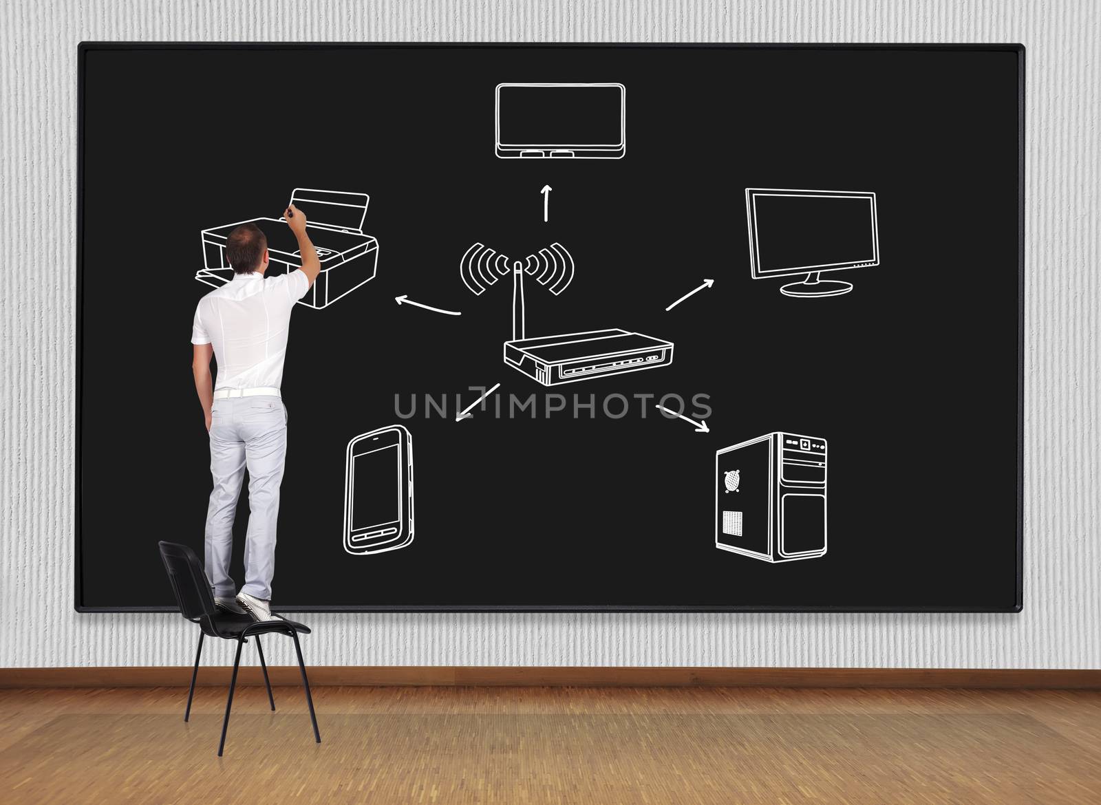 man standing on a chair and drawing computer network