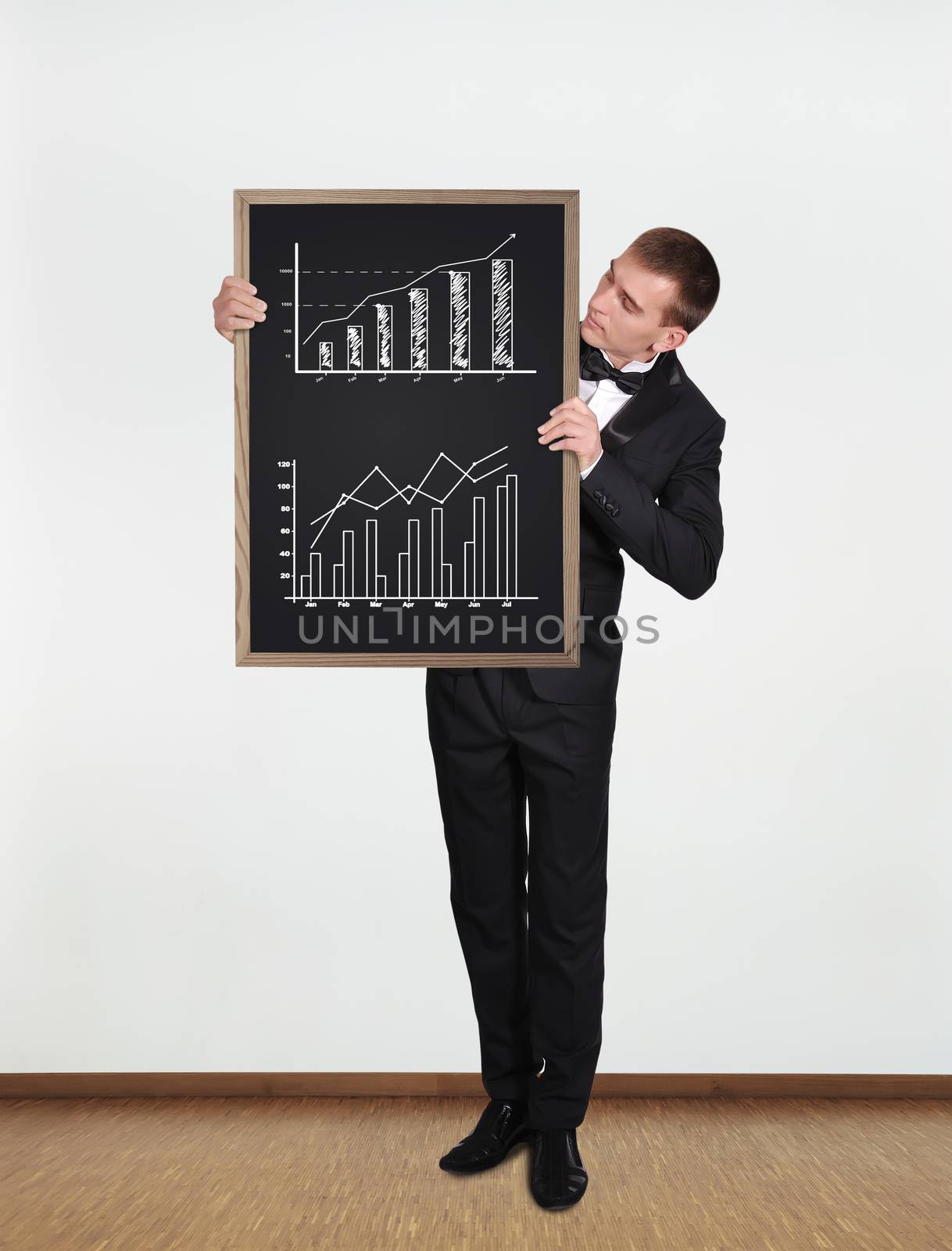 businessman standing in office and  holding blackboard with diagram