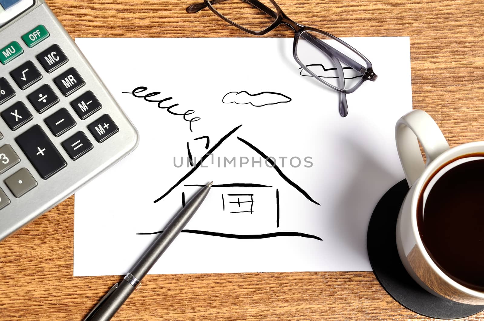 drawing abstract  house on businessman desktop