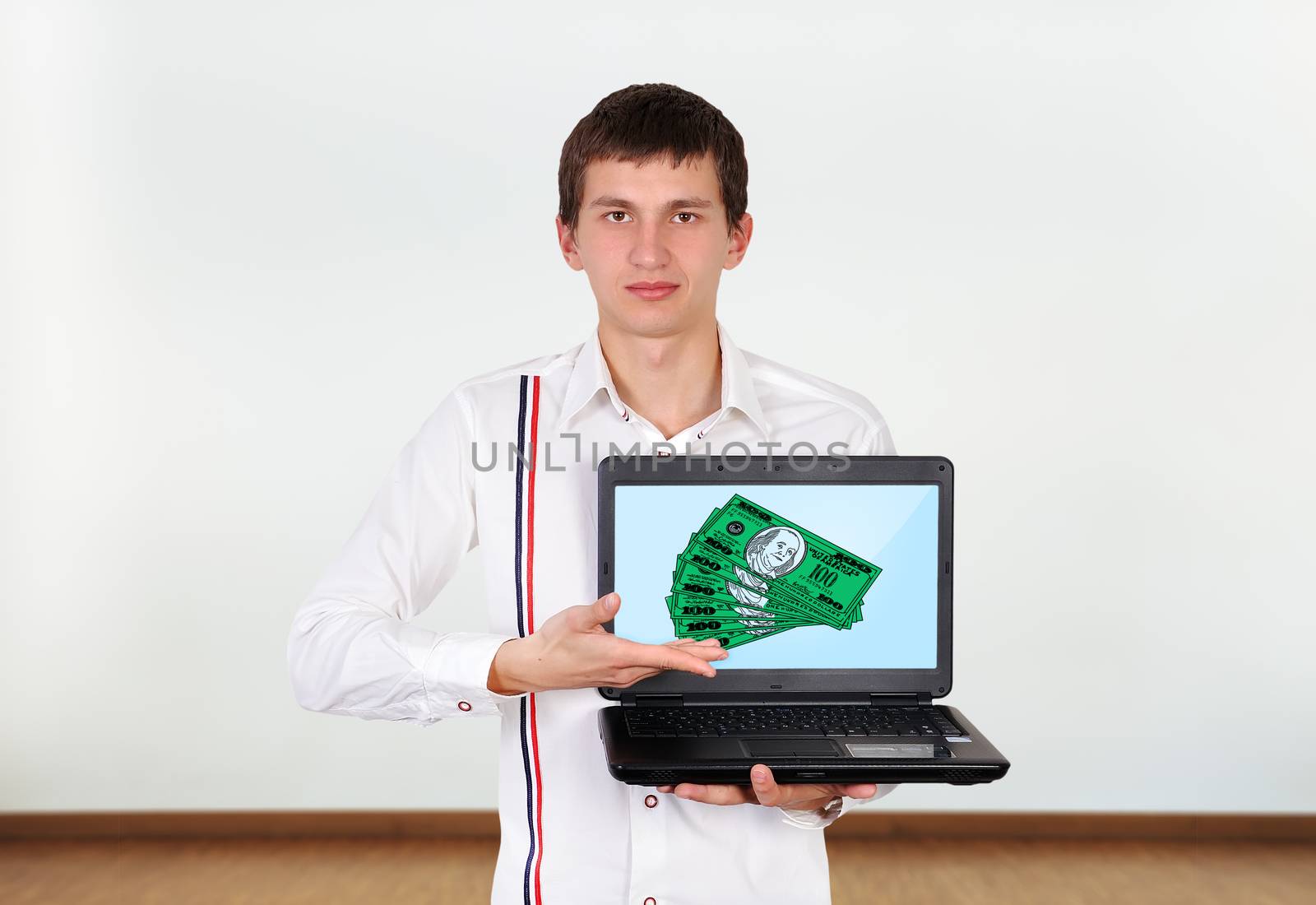 boy holding laptop with dollars on screen