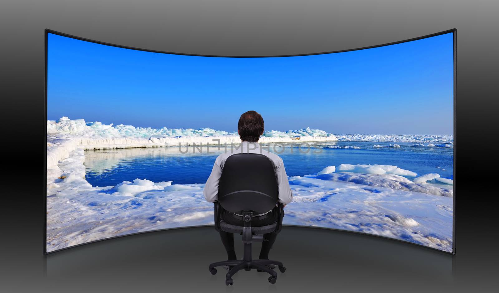 businessman sitting in movie house and looking at  frozen sea