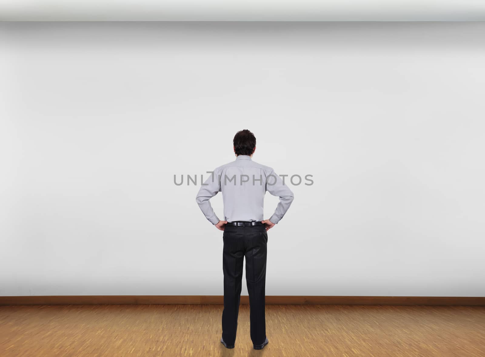 businessman in office looking at blank wall