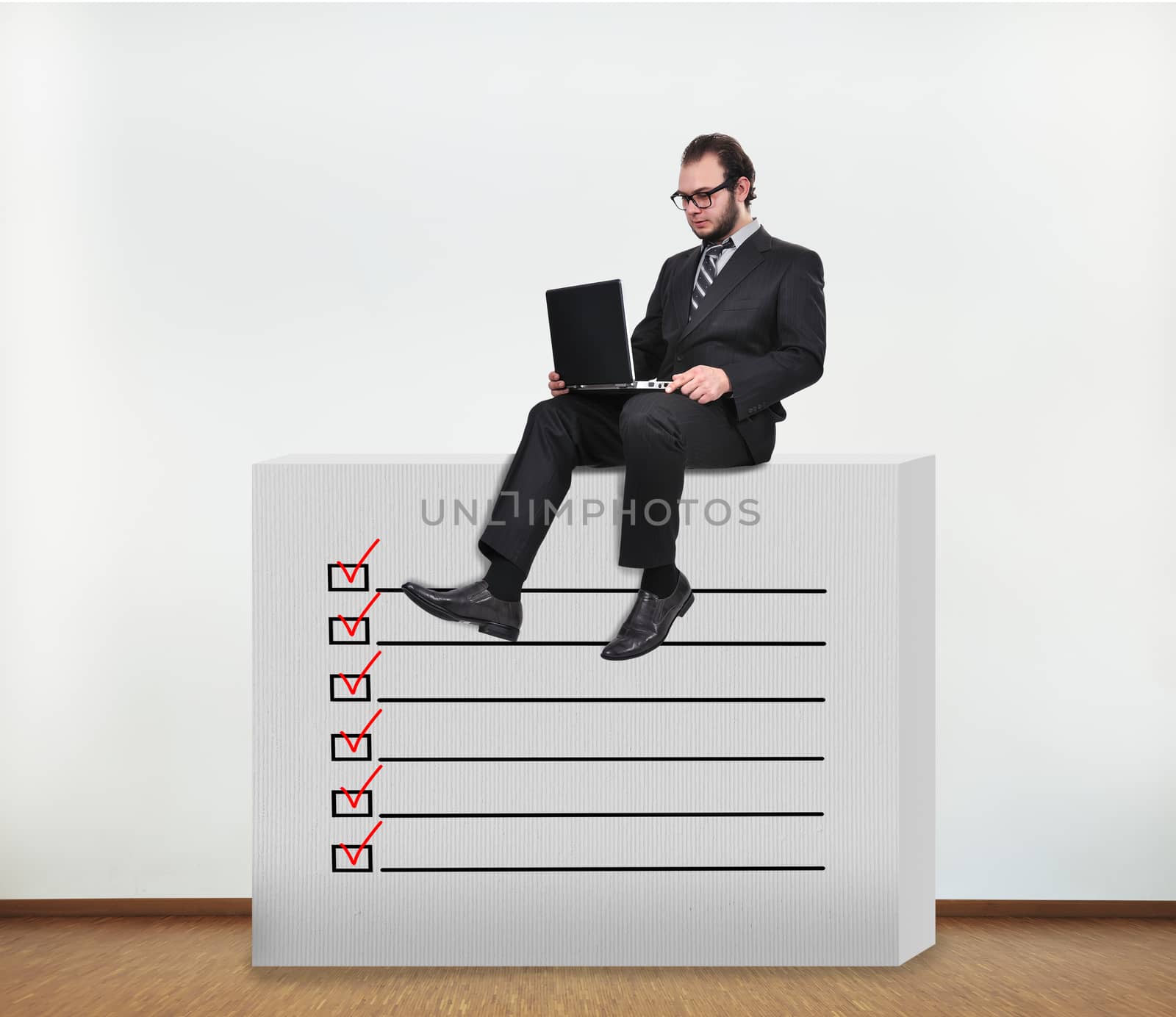 businessman sitting on concrete wall with application form