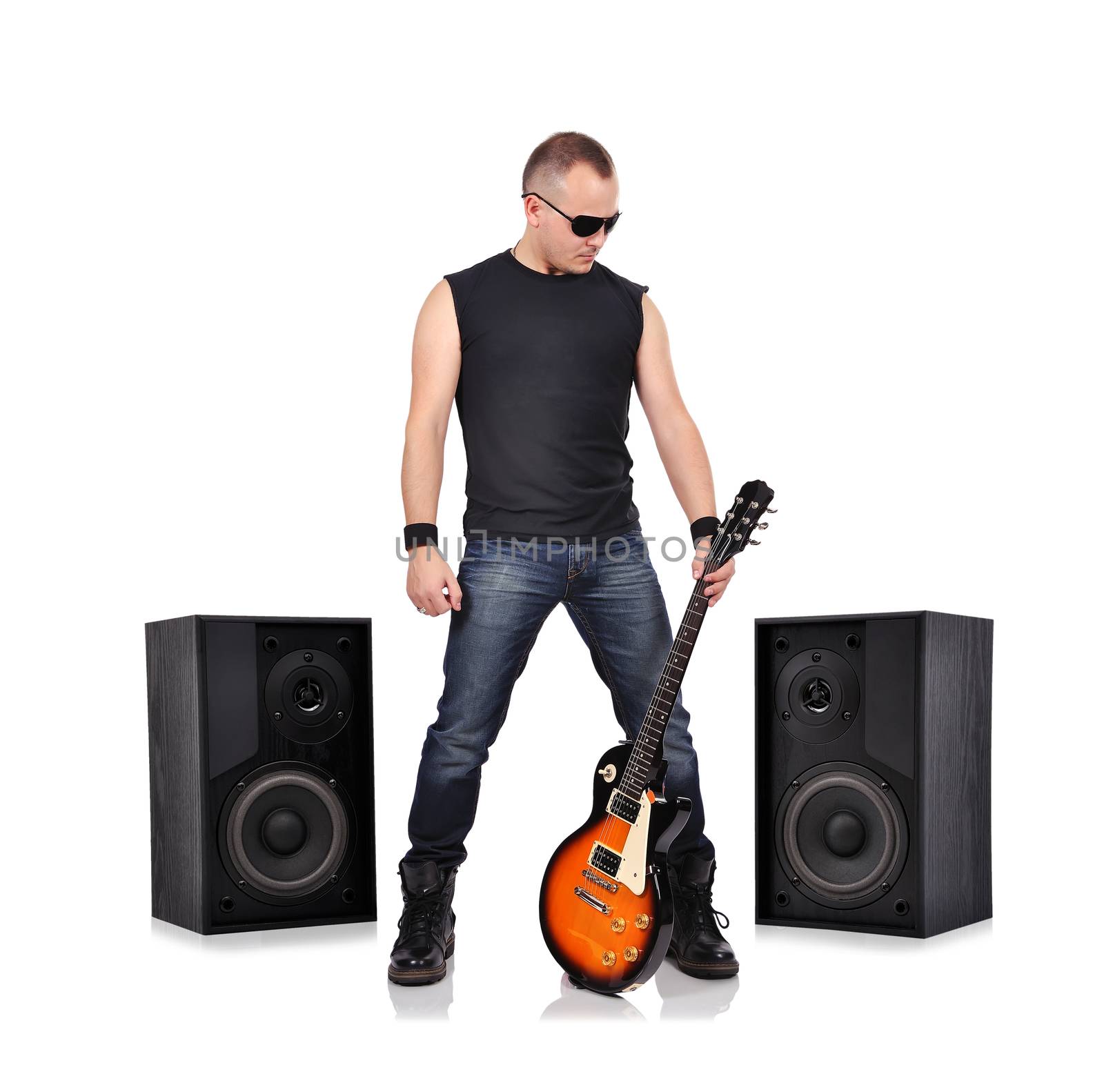 rock musician holding electrical guitar and big speakers