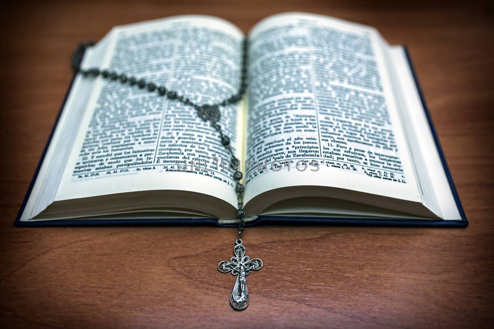 Rosary beads and a holy bible by digicomphoto