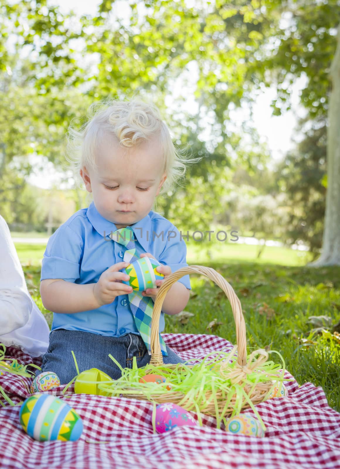 Cute Little Boy Enjoying His Easter Eggs Outside in Park by Feverpitched