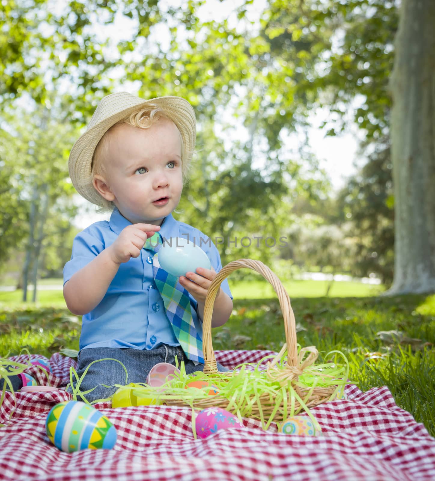 Cute Little Boy Enjoying His Easter Eggs Outside in Park by Feverpitched