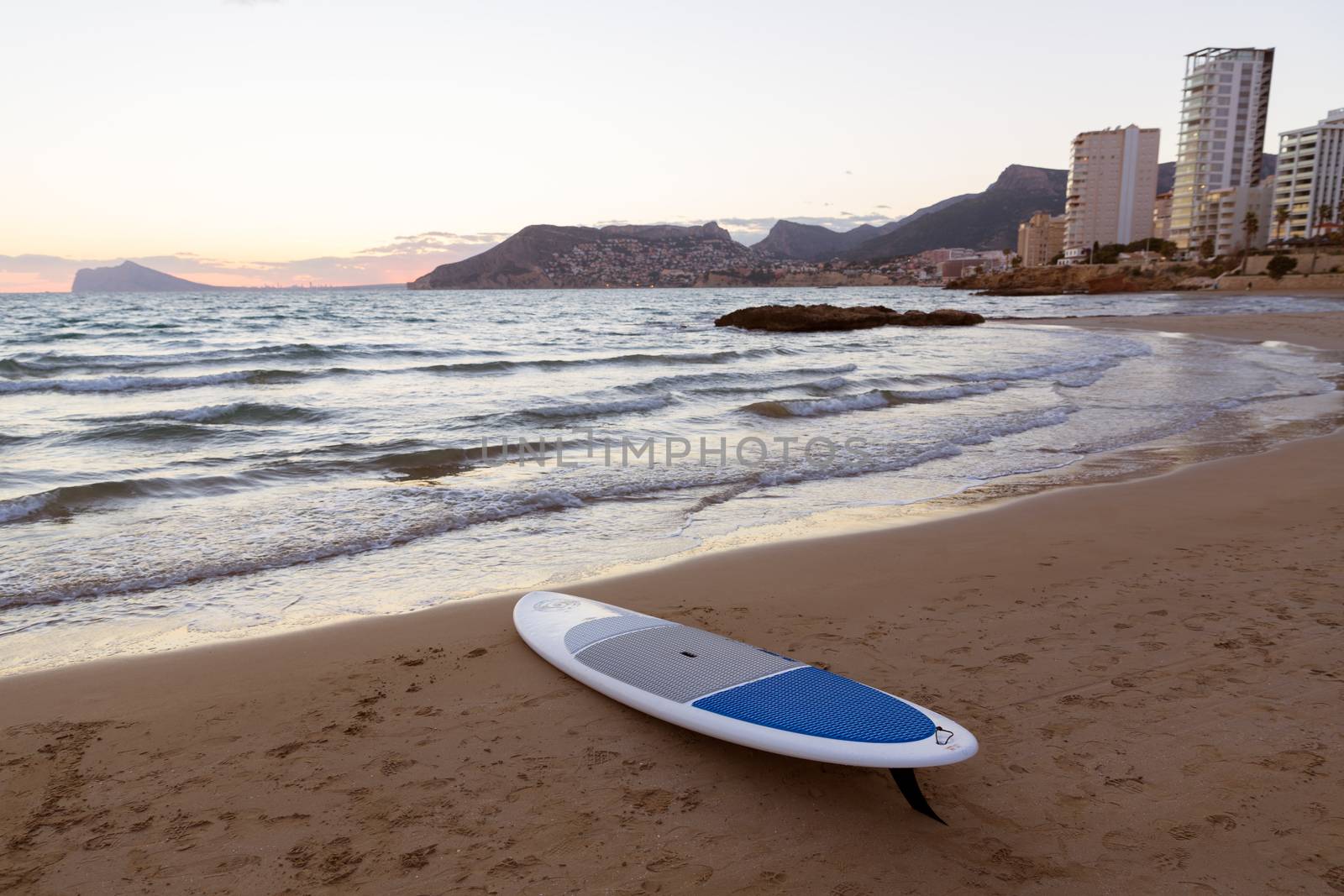 Calpe Alicante sunset at beach Cantal Roig in Mediterranean Spain with paddle sufboard