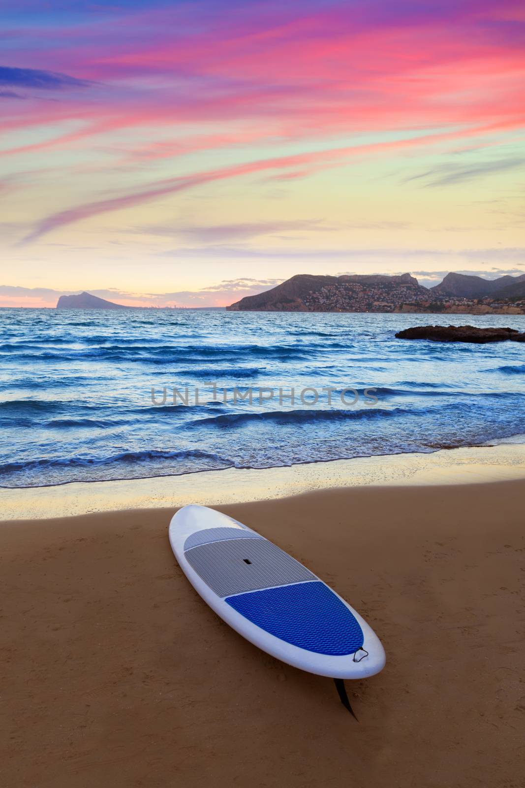 Calpe Alicante sunset at beach Cantal Roig in Mediterranean Spain with paddle sufboard