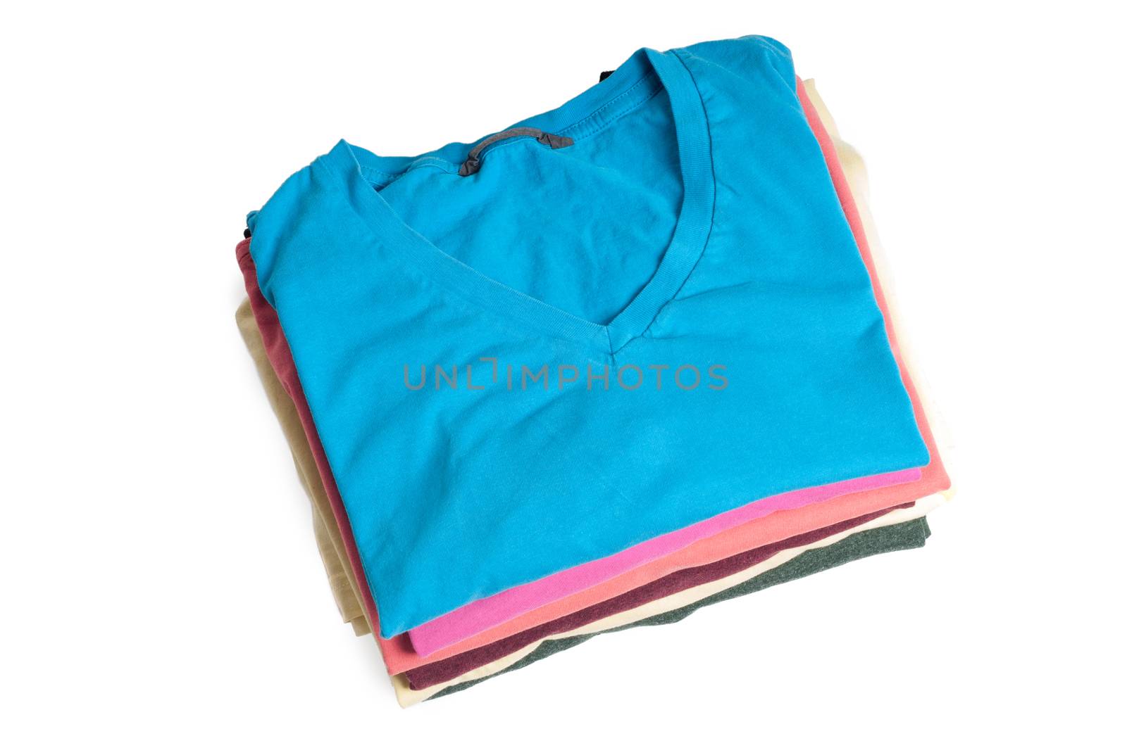 Stack of colored t-shirts on the light background