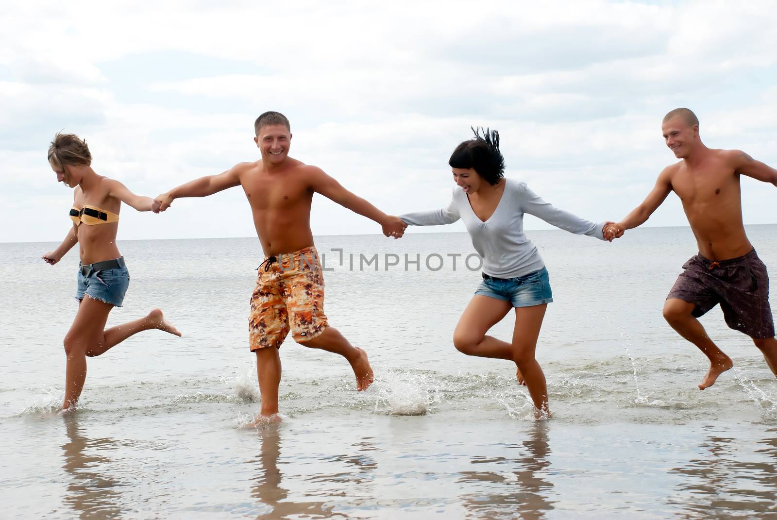 Group of friends having fun at the beach  by Anpet2000
