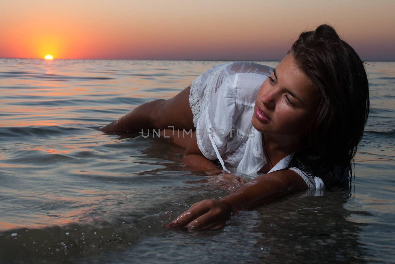 The attractive girl in a white wet transparent dress laying  in  by Anpet2000