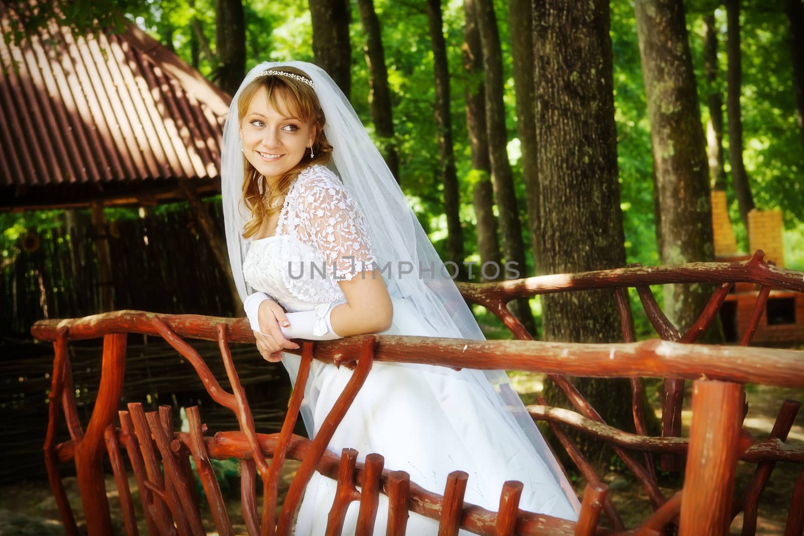 Portrait of the young bride in park