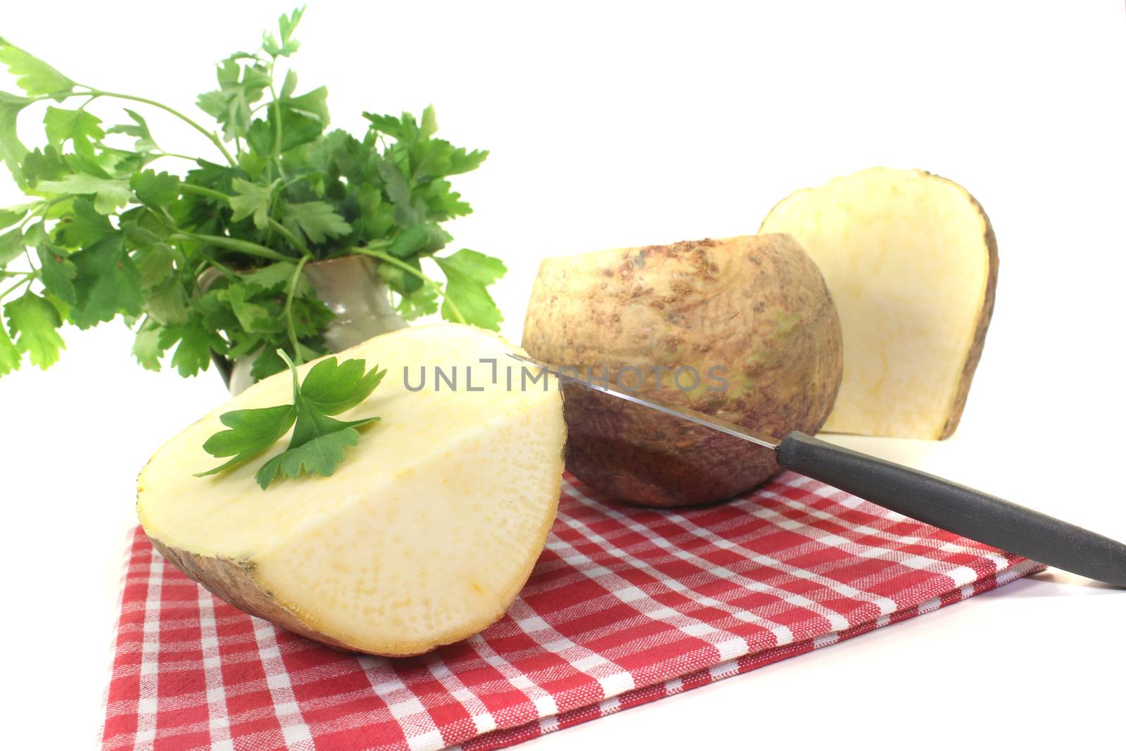 yellow rutabaga with parsley and napkin on a bright background