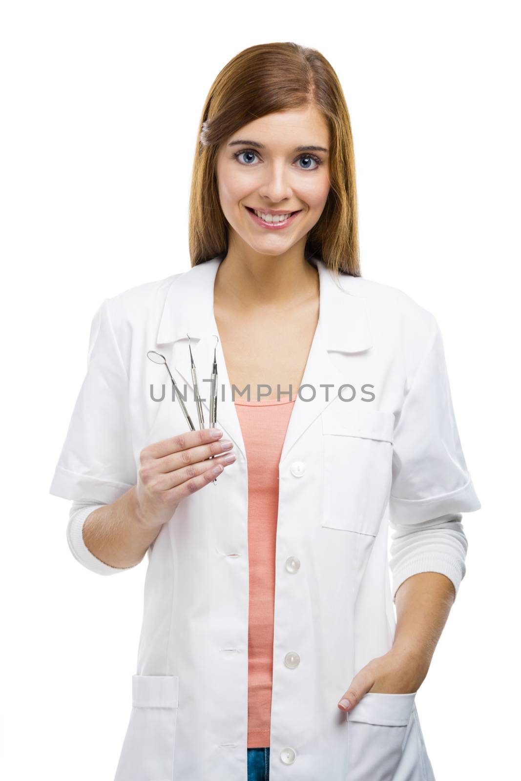 Beautiful and attractive female dentist with tools, isolated over a white background