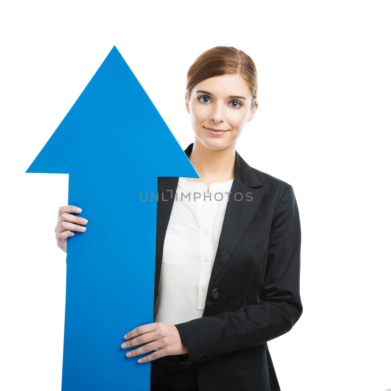 Beautiful young business woman holding a blue arrow, over a white background