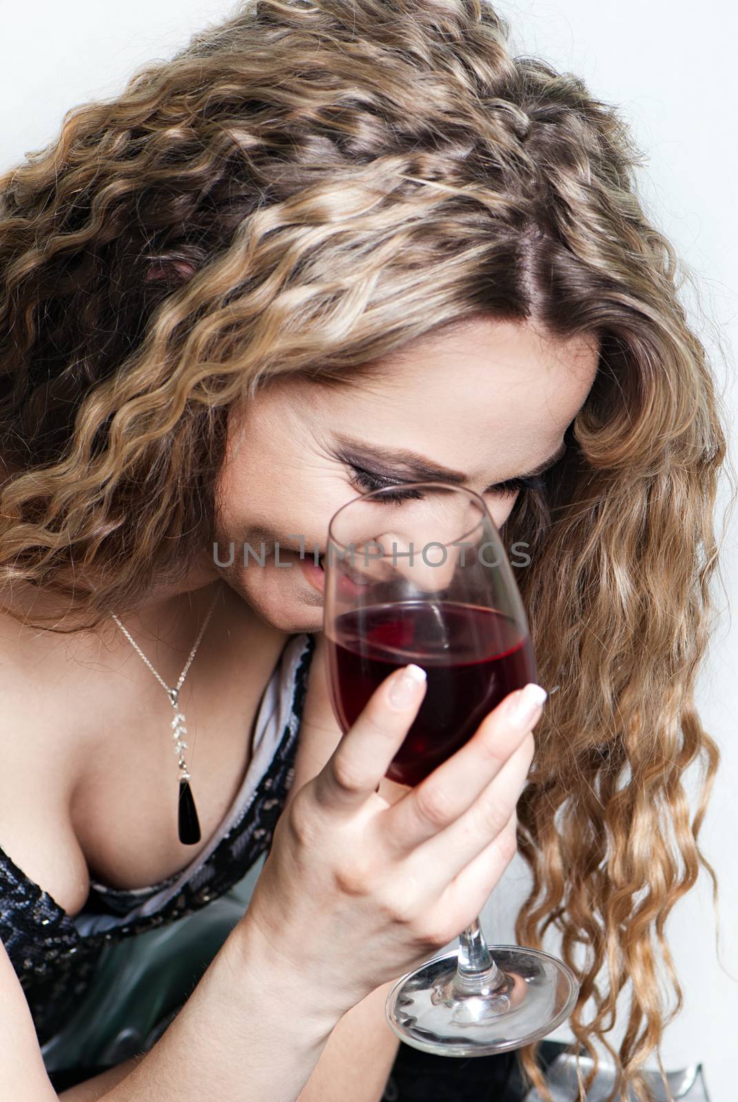 Isolated portrait shot of a beautiful caucasian woman with a red wine glass.
