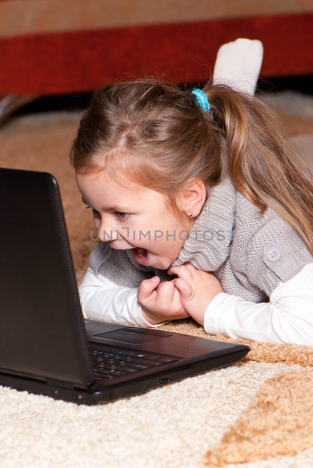 Portrait of a little girl with a laptop