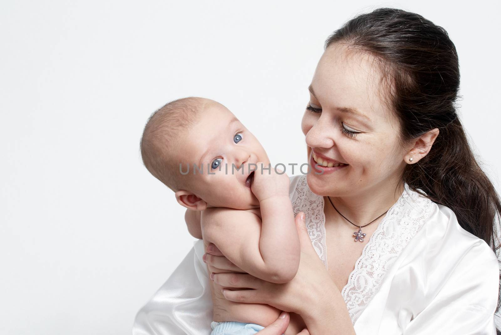 Portrait baby with happy mother on light background