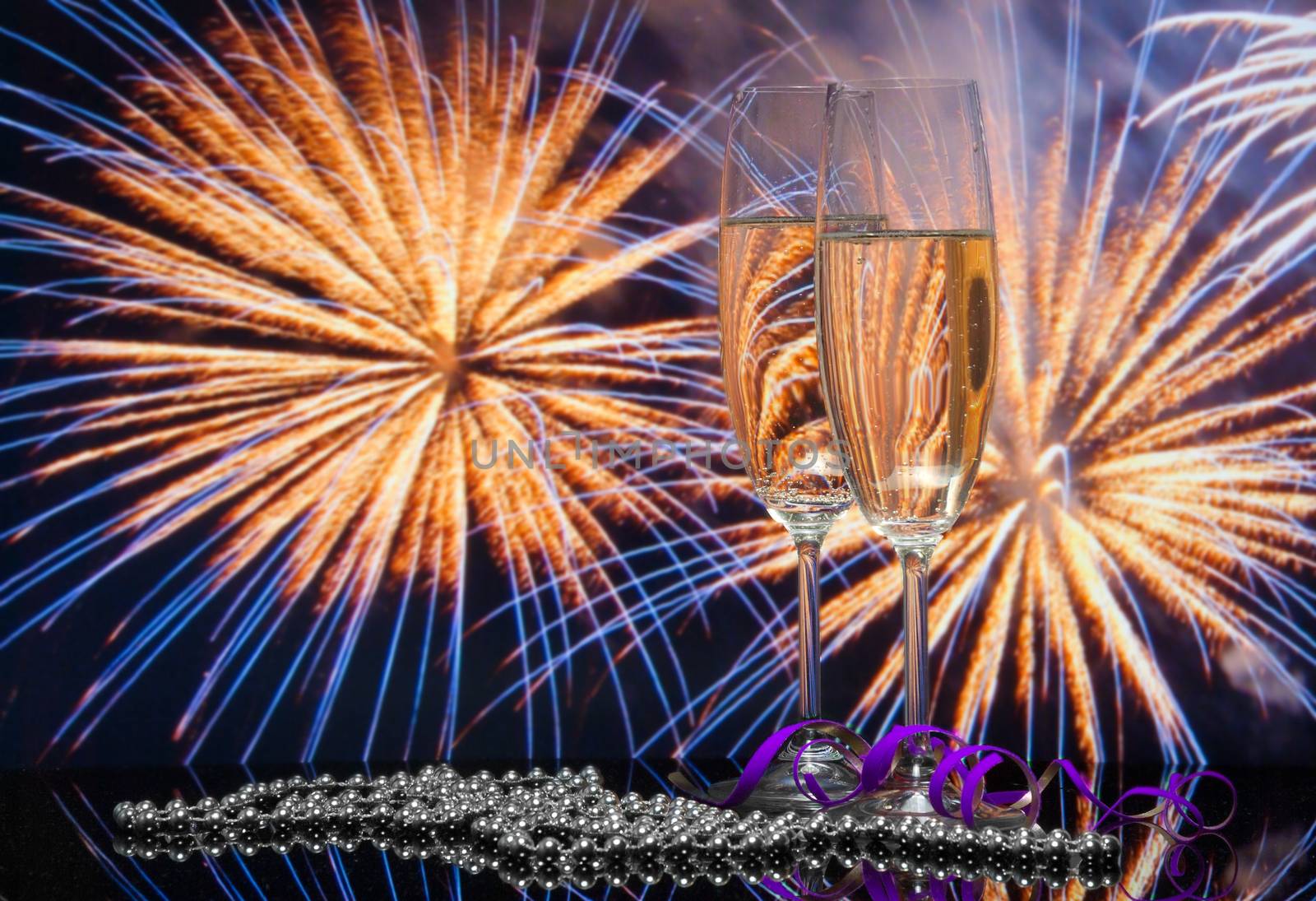 Glasses with champagne against fireworks 