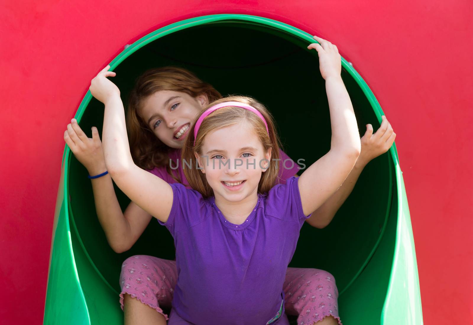 kid sister girls playing in the park playground by lunamarina