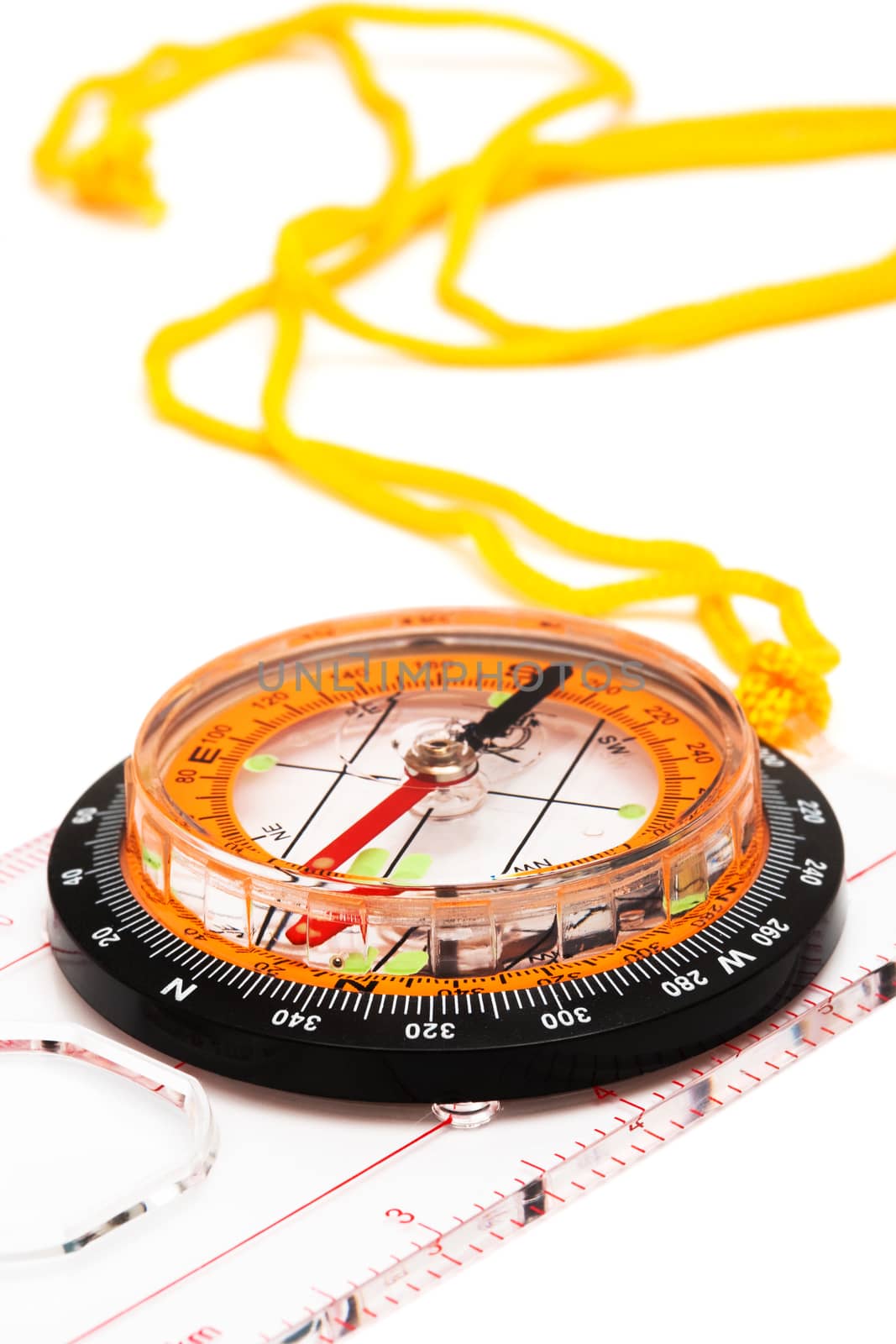 Compass with a yellow cord on a white background