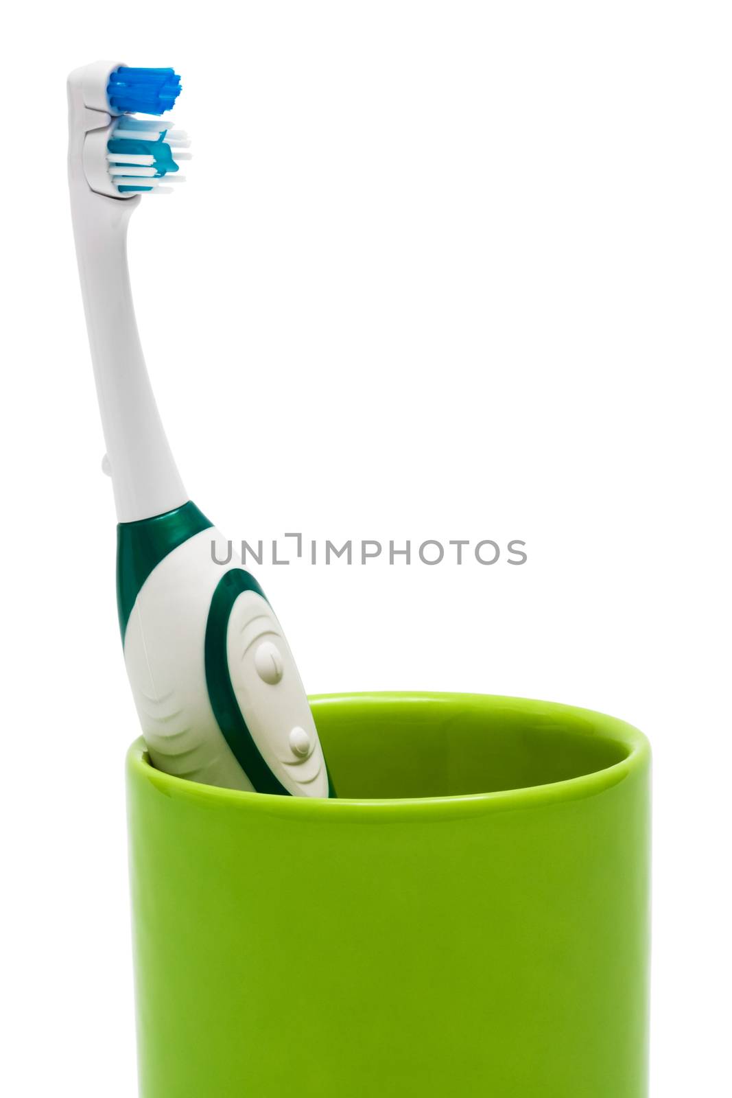 Toothbrush in a green glass by terex