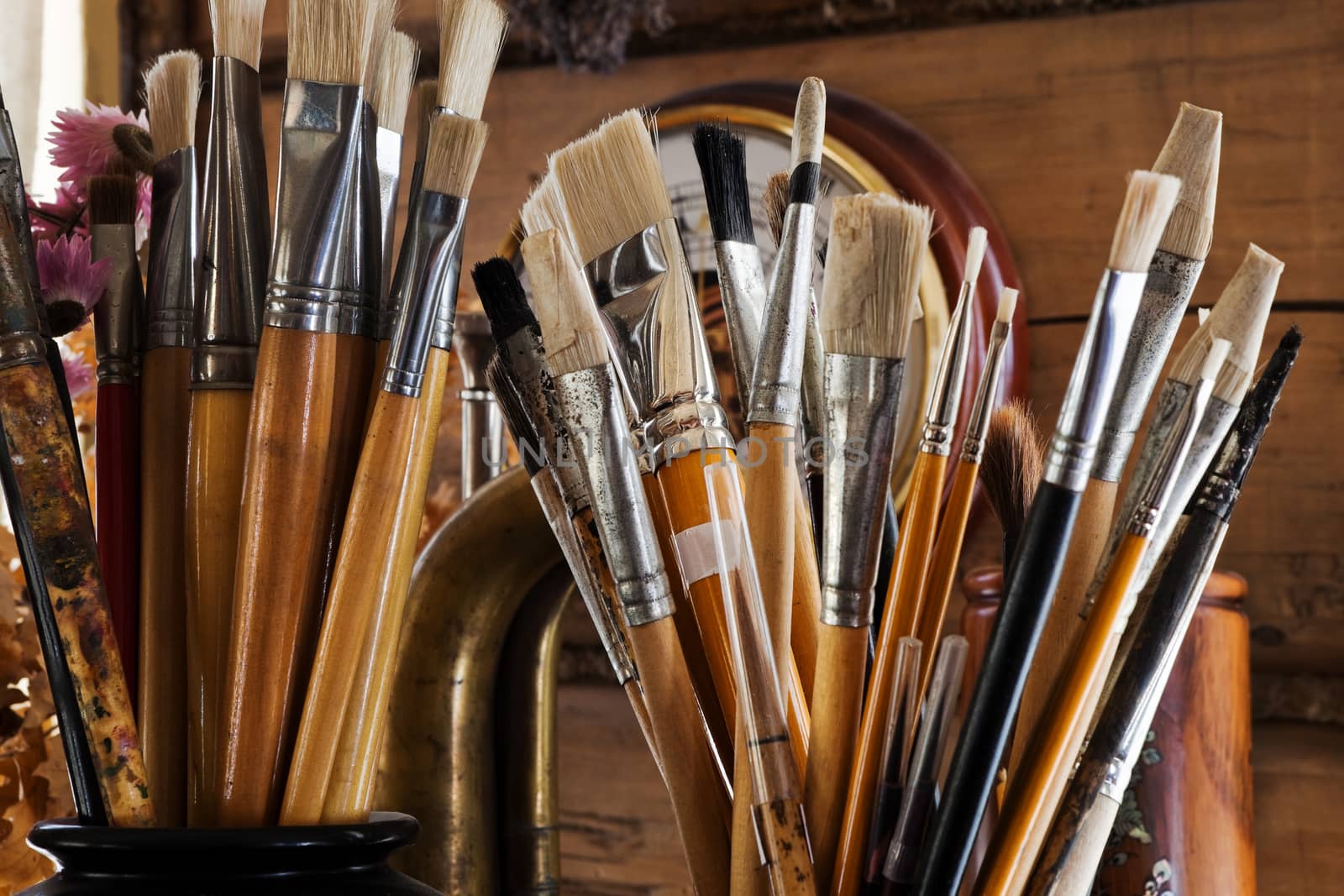 a lot of brushes in the studio of the artist