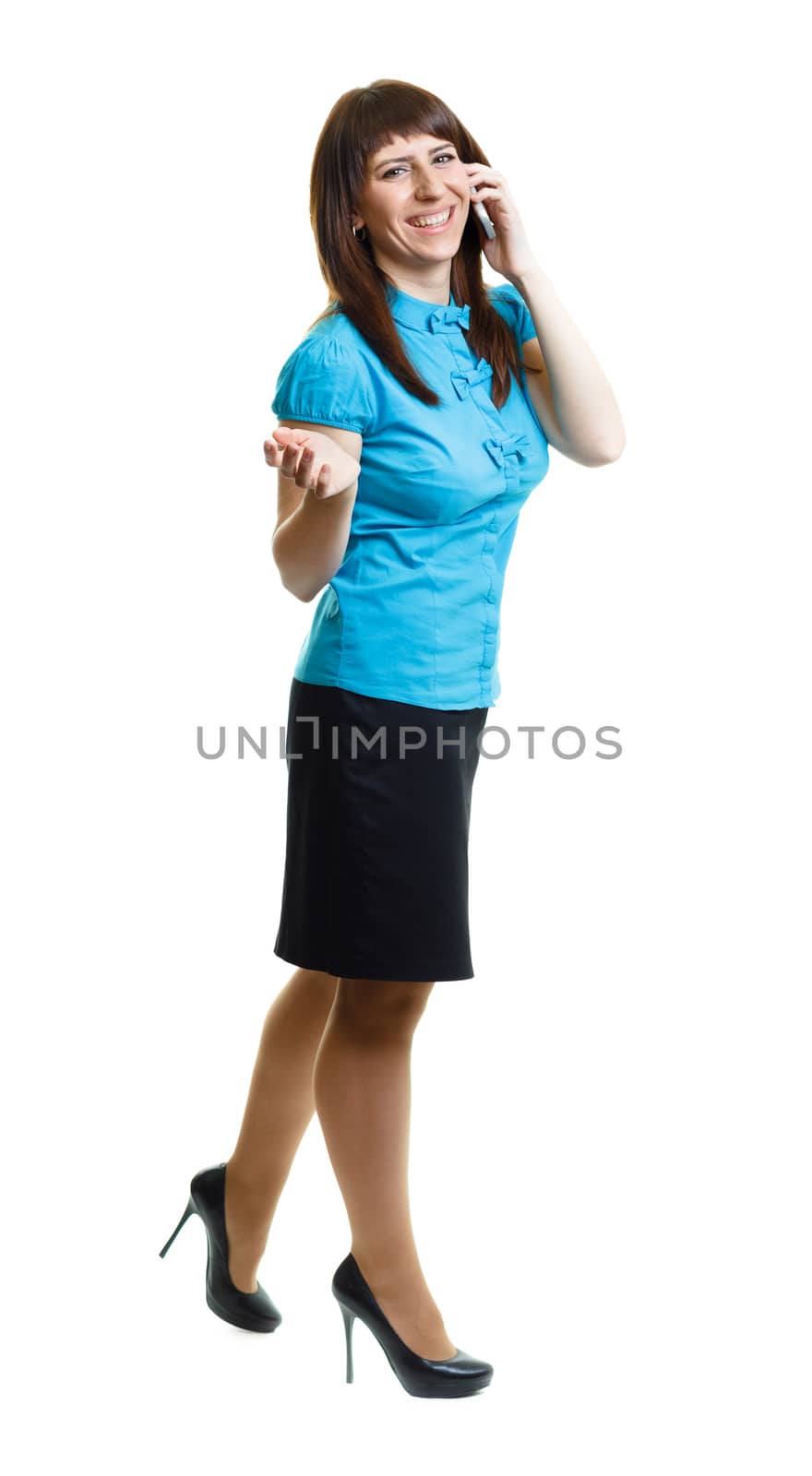 Smiling confident attractive girl talking on the phone on the move on a white background