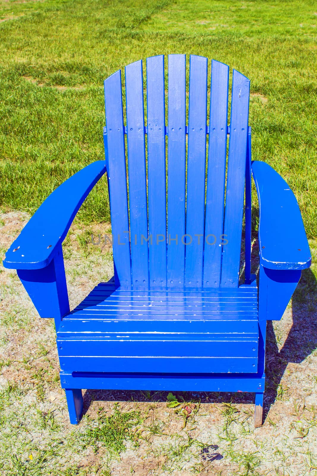 Single bright blue Adirondack chair.