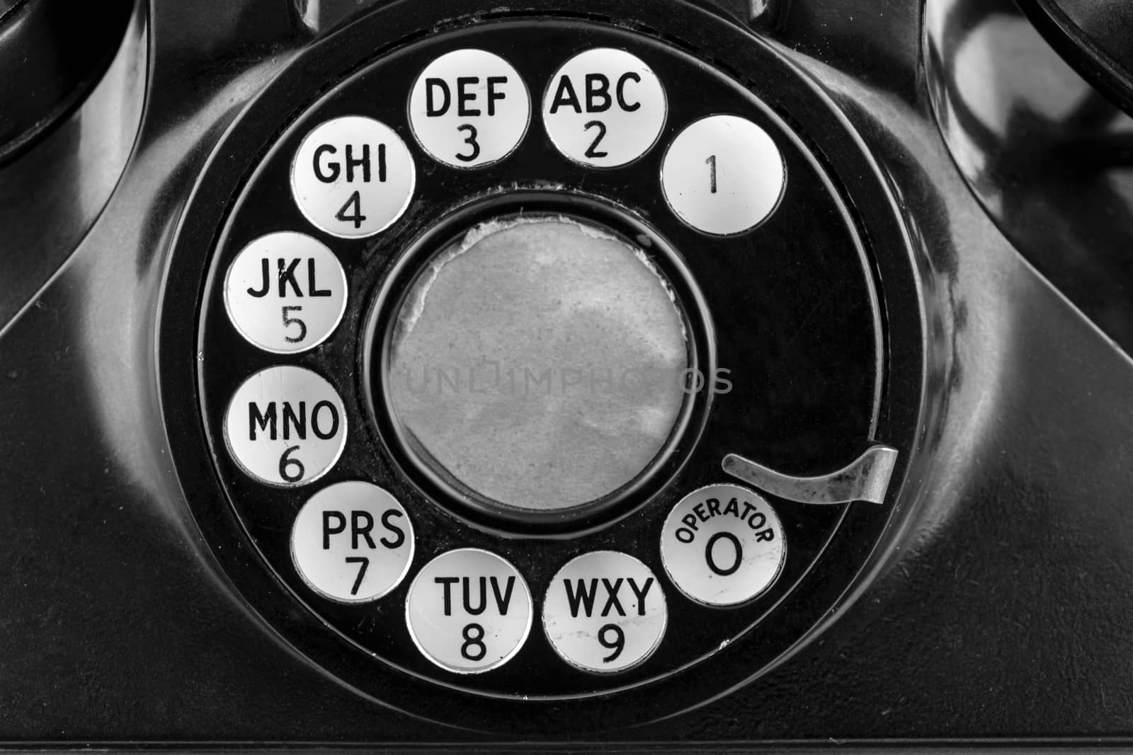 Rotary phone dial in black and white. 